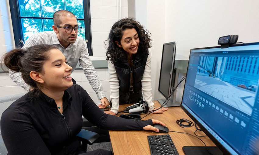 engineering-professor-students-monitor Professor and graduate students viewing monitor